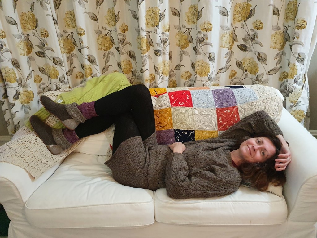 Rachel on the sofa in her new jumper and shorts.