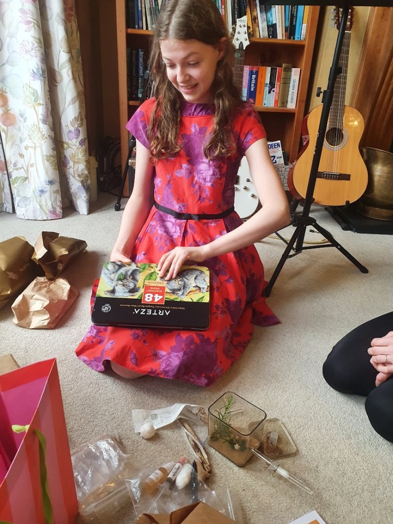 Elizabeth looking at some colouring-in pens she just opened.