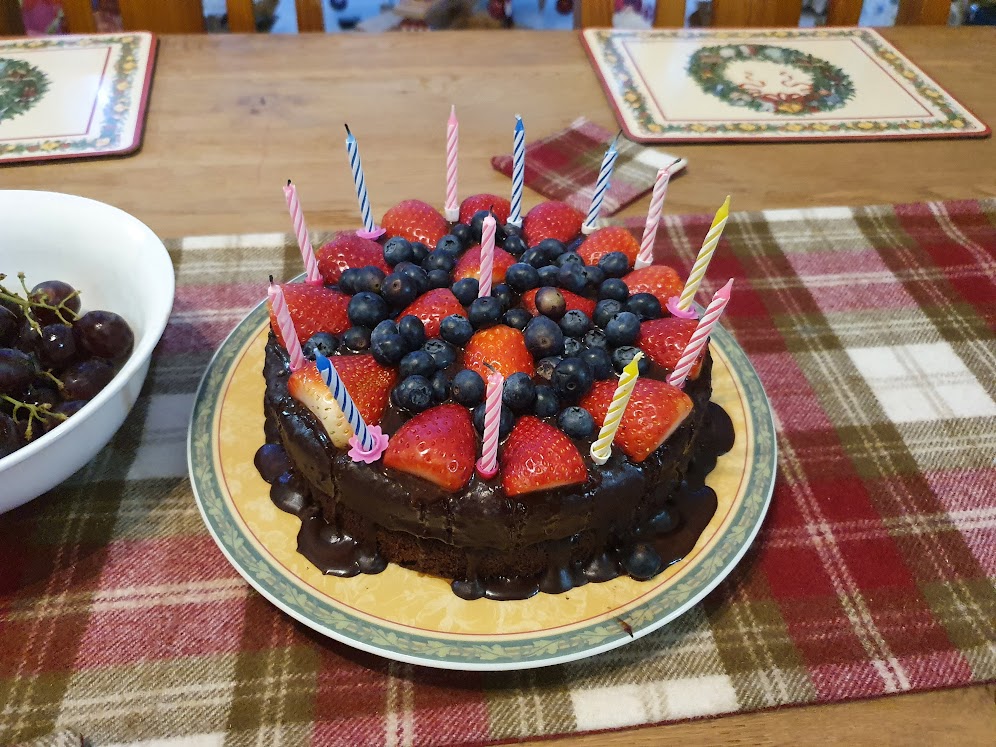 The chocolate cake I made for Elizabeth. It's covered in chocolate and decorated with strawberries and blueberries. 