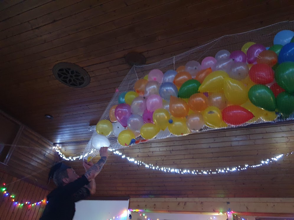 A big bag of balloons tied to the ceiling