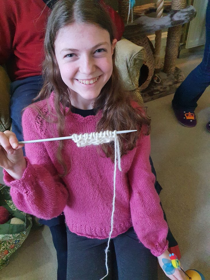 Elizabeth proudly holding up her knitting