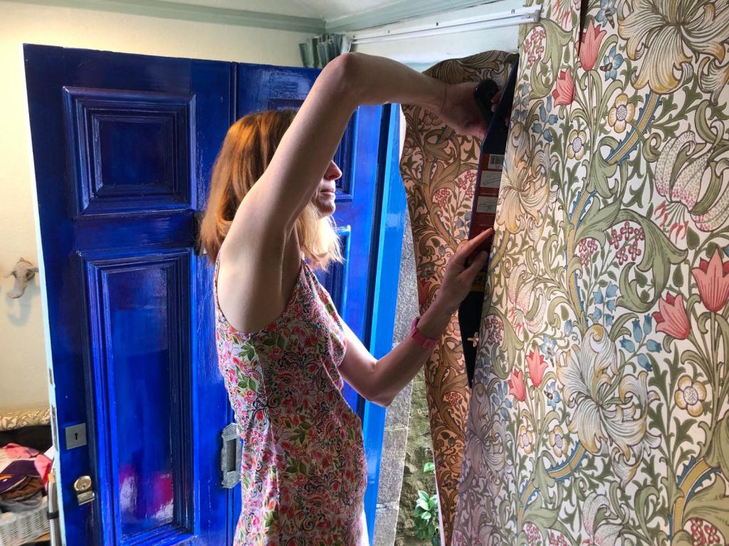 Me hanging wallpaper and struggling to do the corner