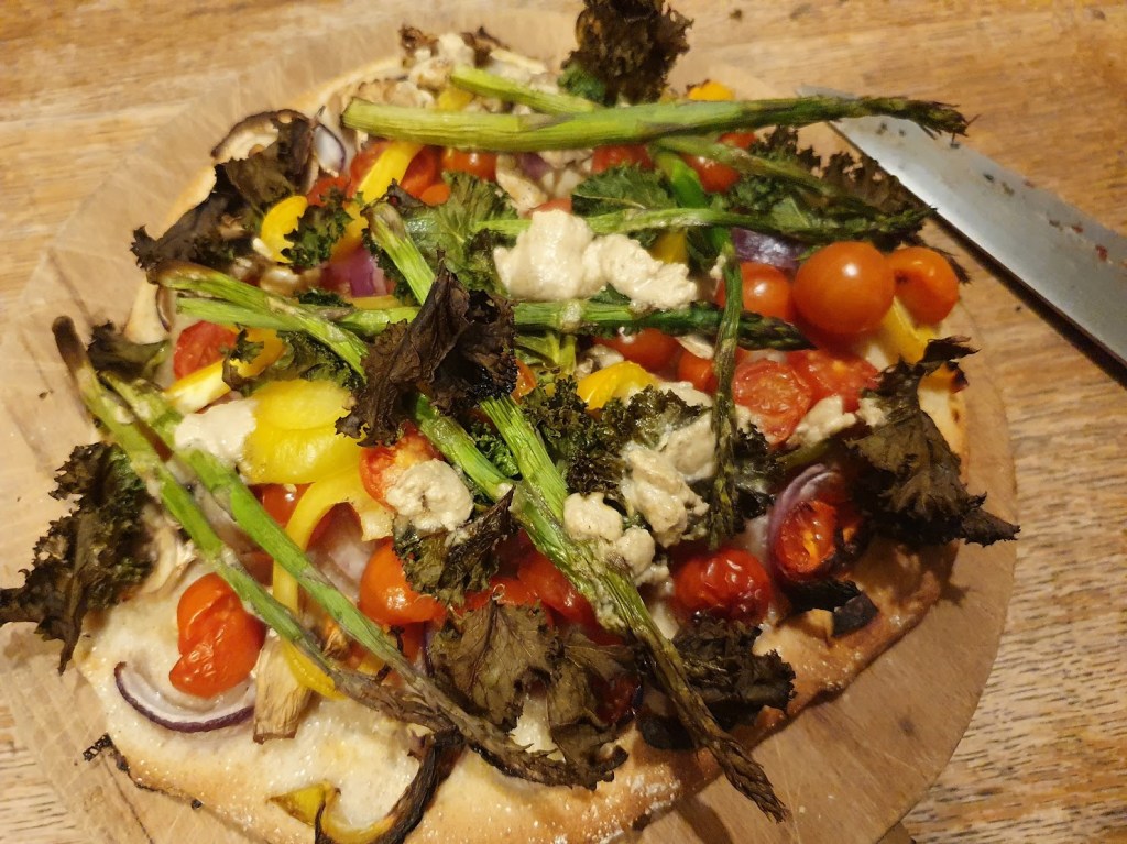My pizza with yellow peppers, onions, mushrooms, tahini, cherry tomatoes, asparagus, kale and I think that's it.