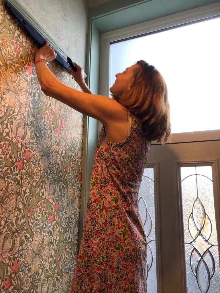 Me cutting the edge off after having pasted the wallpaper