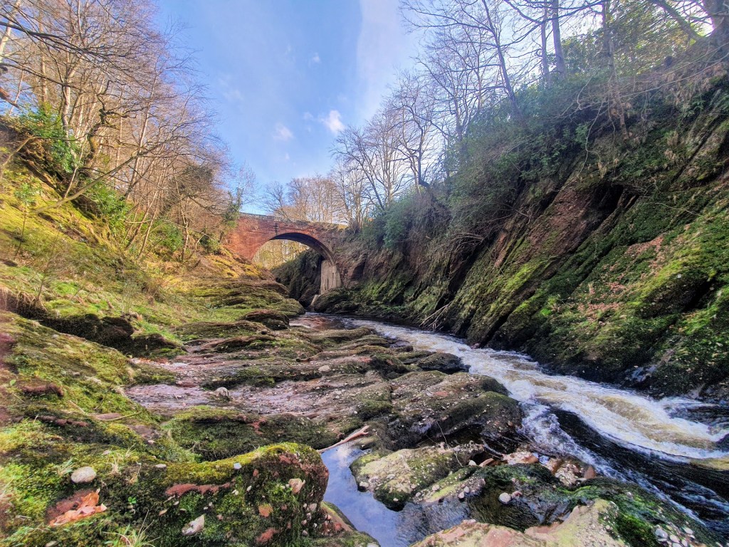 The view looking downstream to Gannochy bridge on a sunny day. 