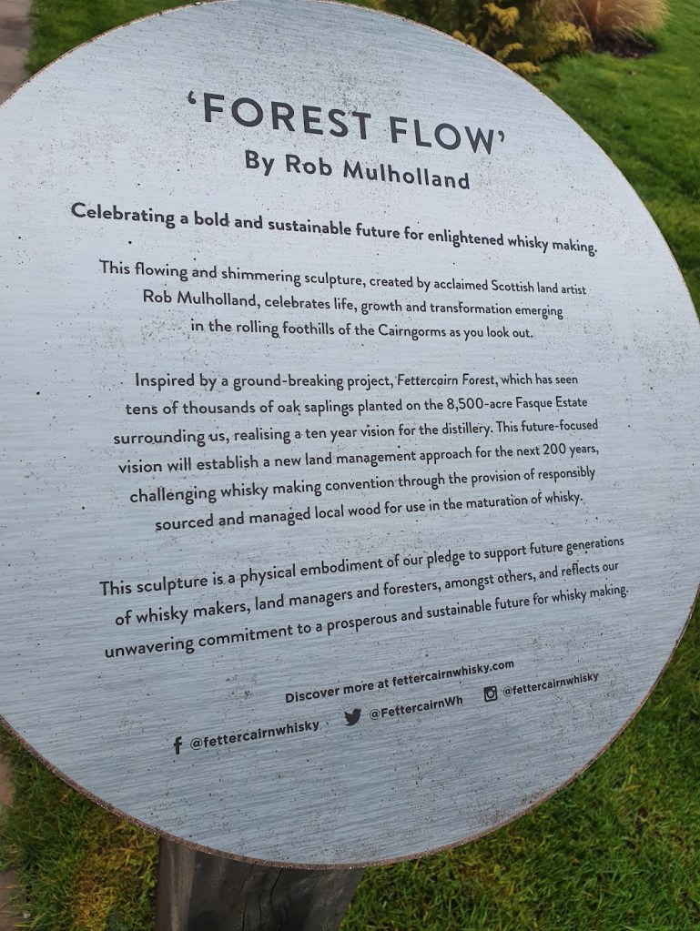 Plaque explaining the vision for the distillery and the sculpture that was commissioned to celebrate the tree planting.