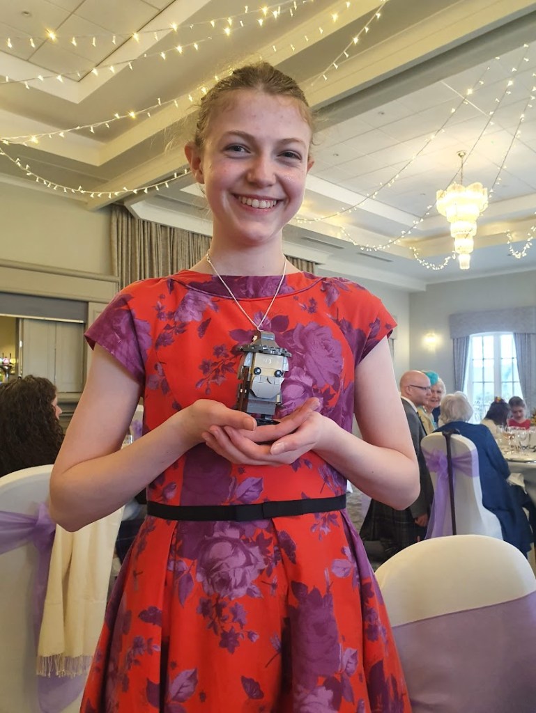 Elizabeth holding her completed Gandalf lego