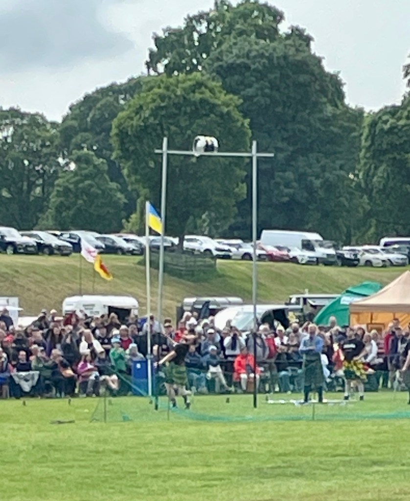 A beer barrel high in the air about to go over the bar. 
