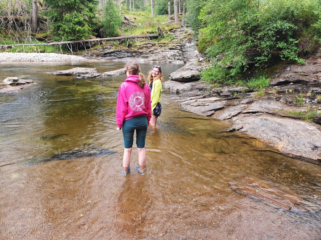 Rachel and Elizabeth wetting their legs in the River Dee