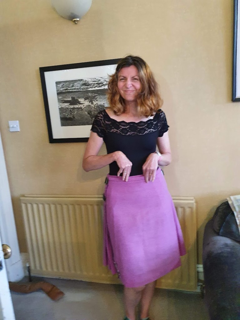 Rachel pulling a face while wearing the kilt.