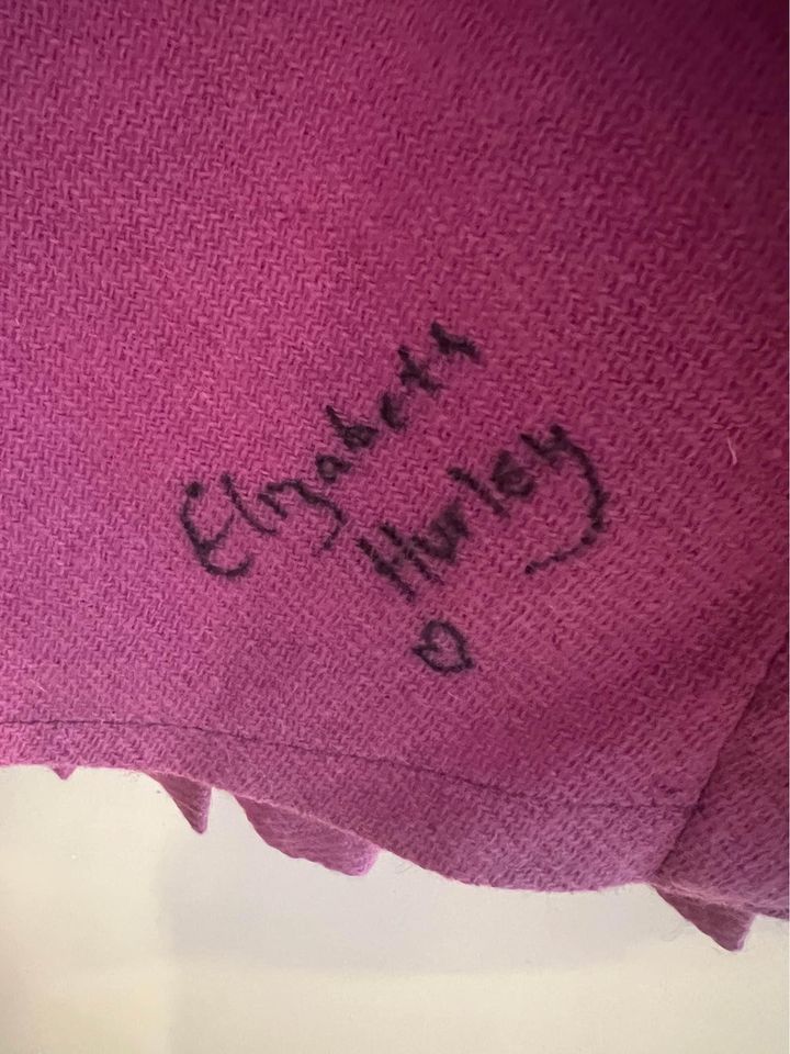 Elizabeth Hurley's signature on the pink kilt with a heart shape