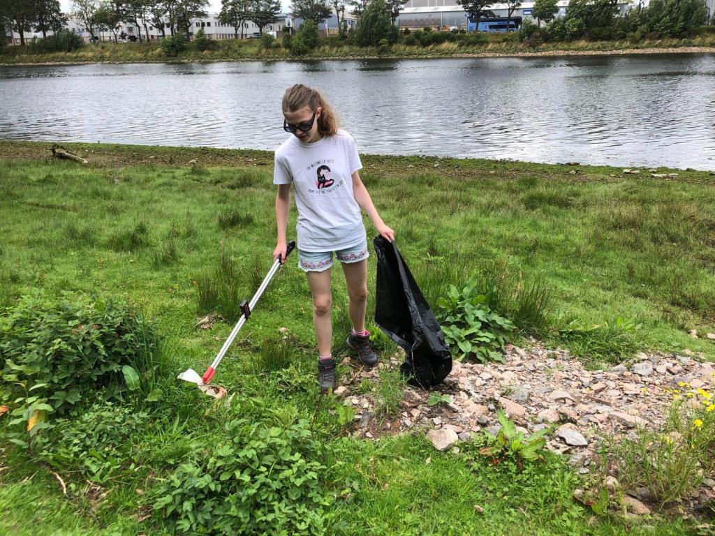Elizabeth picking up litter.