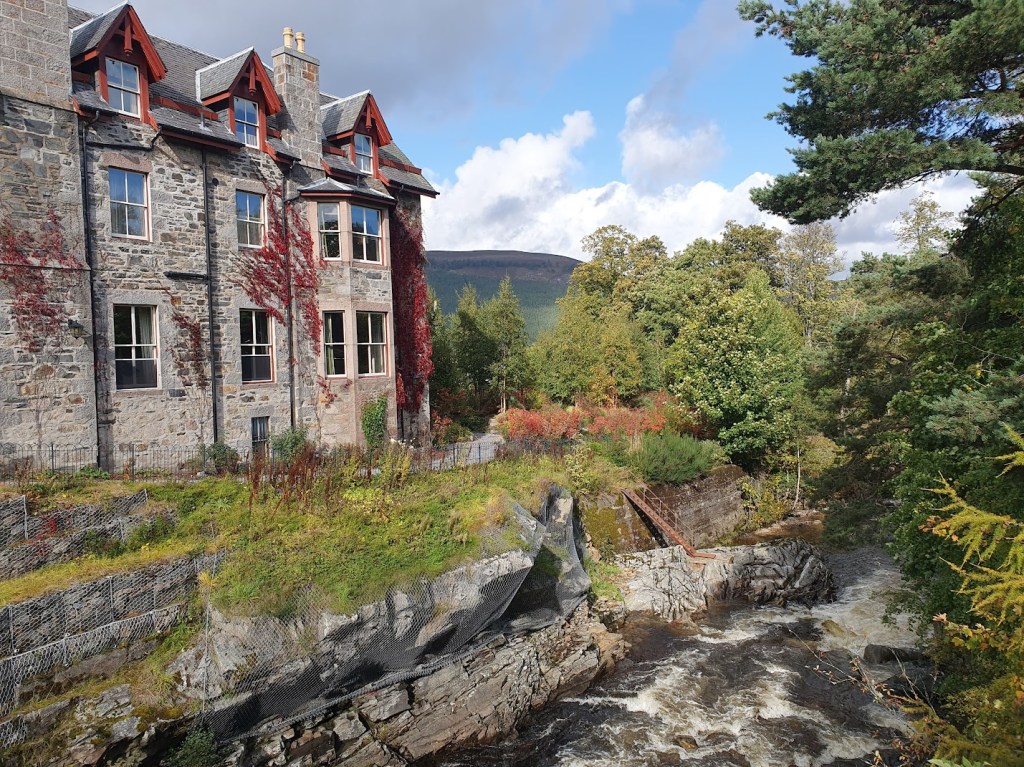 The Fife Arms with red vegetation growing up the side