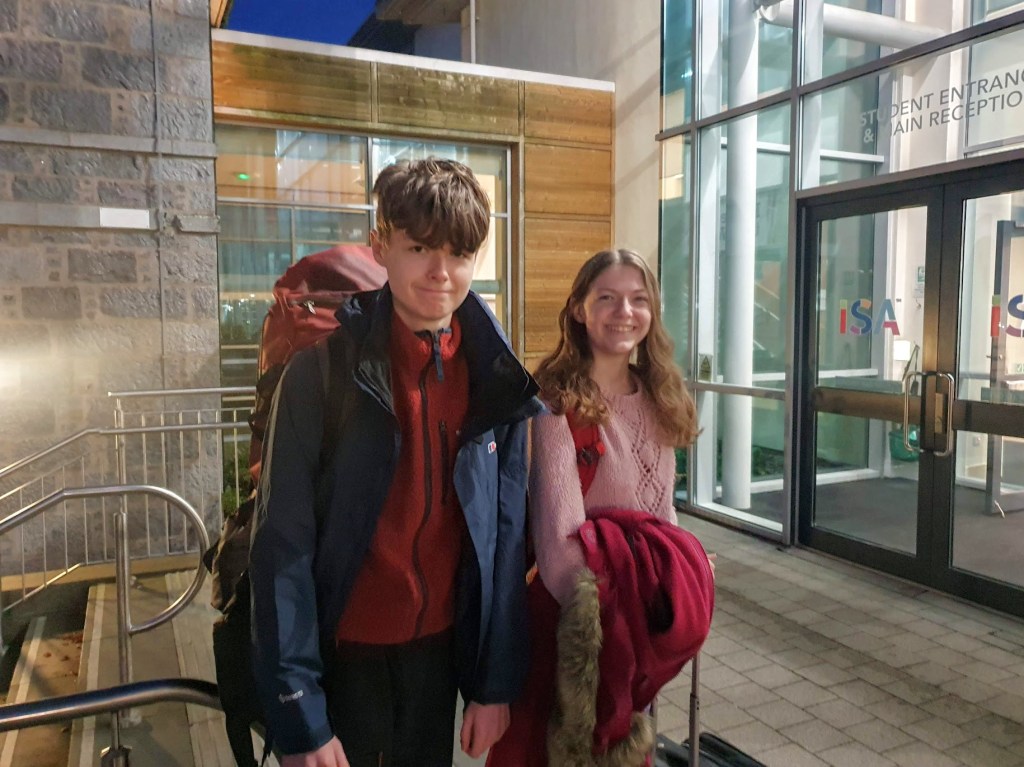 Elizabeth and Daniel outside school ready for their trip