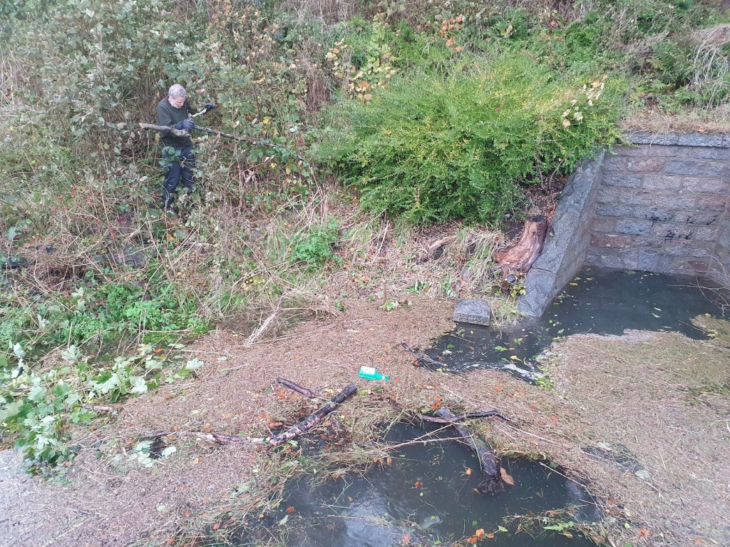 Ben walking down the slope towards the pool of water.