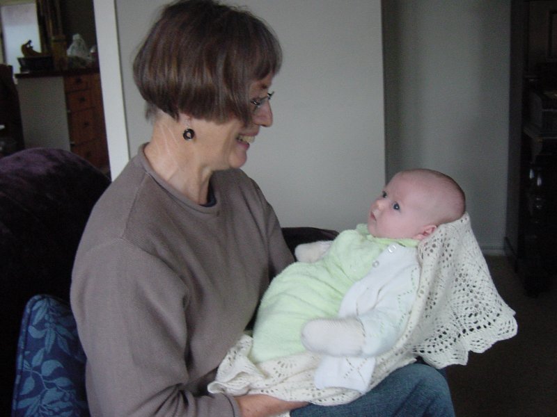 Gran holding Daniel with the baby blanket.
