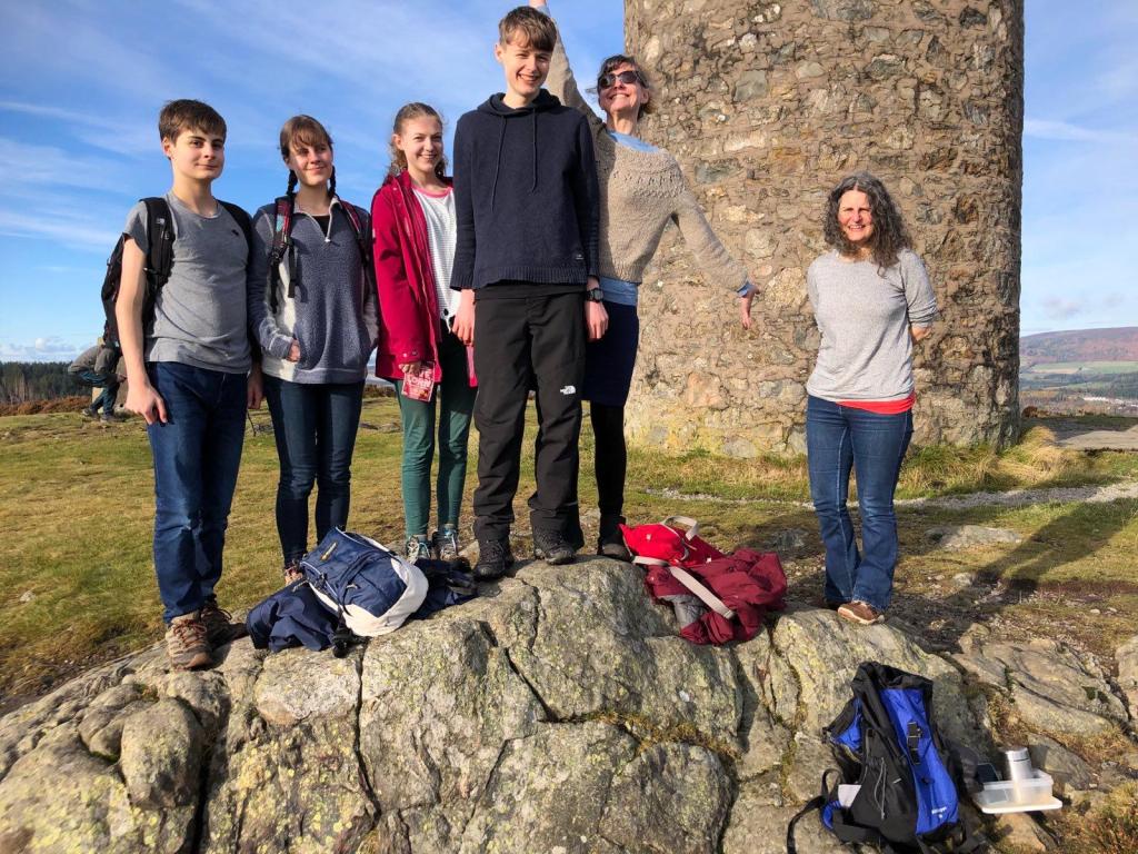 All of us on a rock with the tower behind us and smiling at the camera.