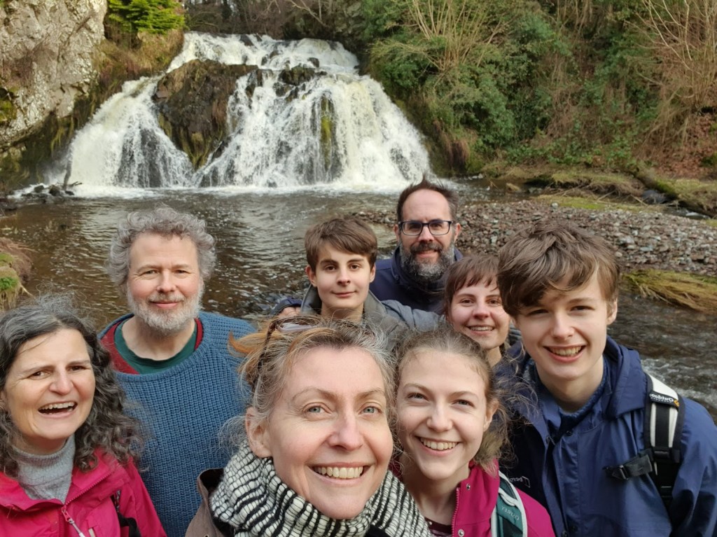 A selfie of all of us with the waterfalls behind us.