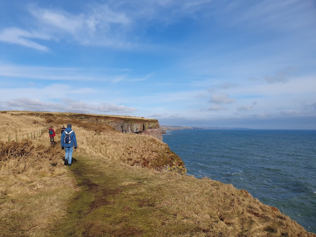 Daniel and Elizabeth walking ahead on the cliff top path.