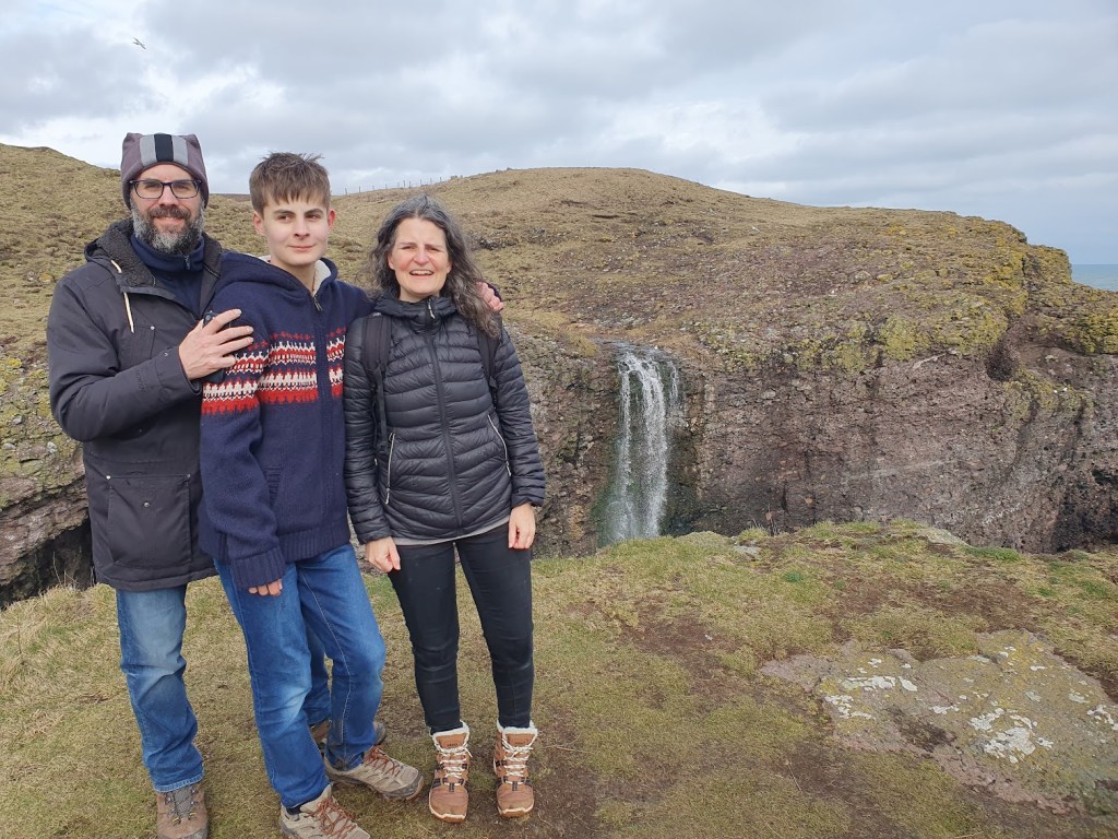 Rem, Michiel, and Aileen with the waterfall behind them. 