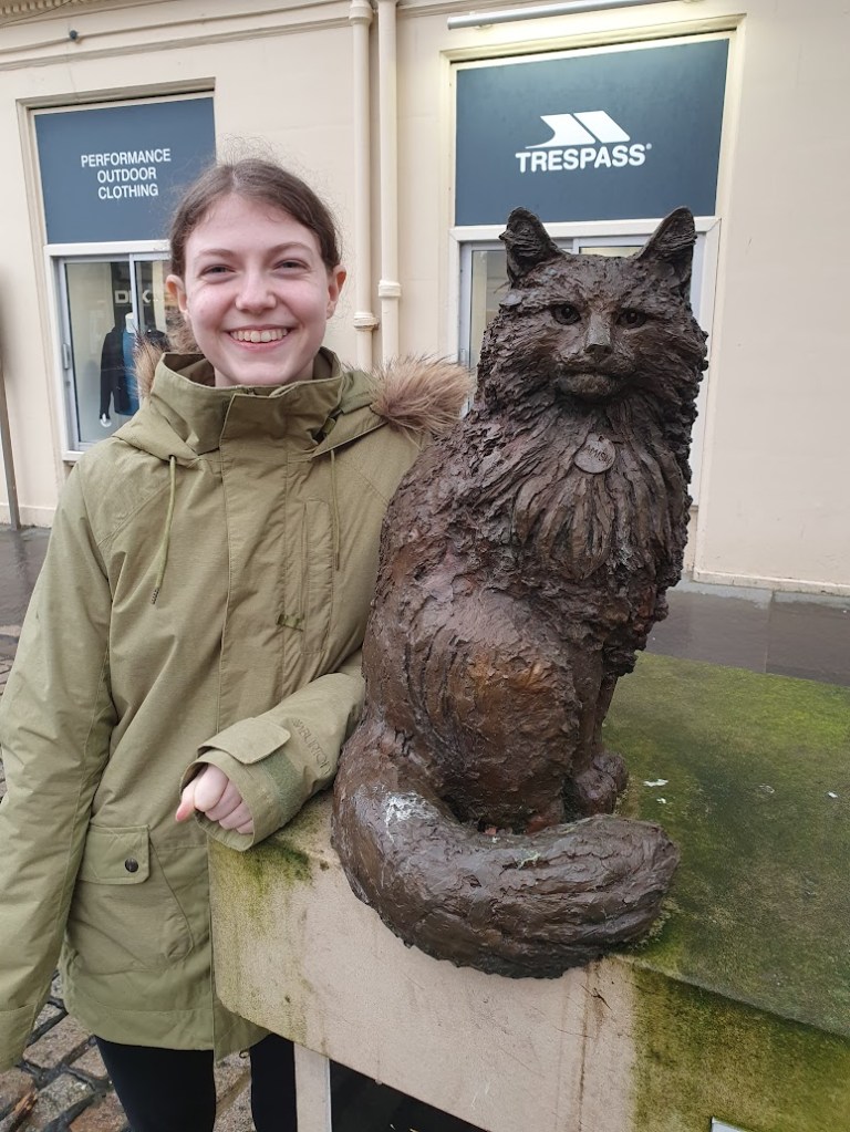 Elizabeth next to the statue of Hamish McHamish.