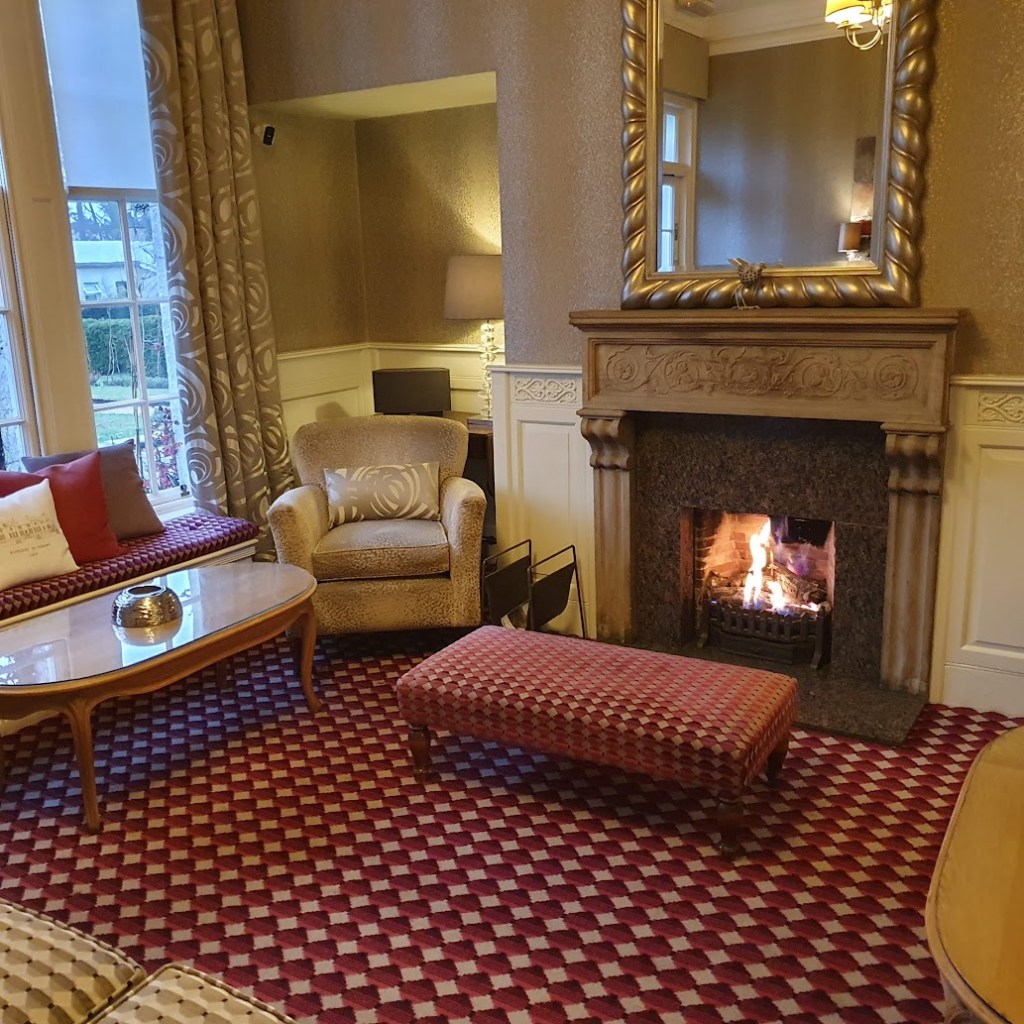 Hotel lounge with a fire.