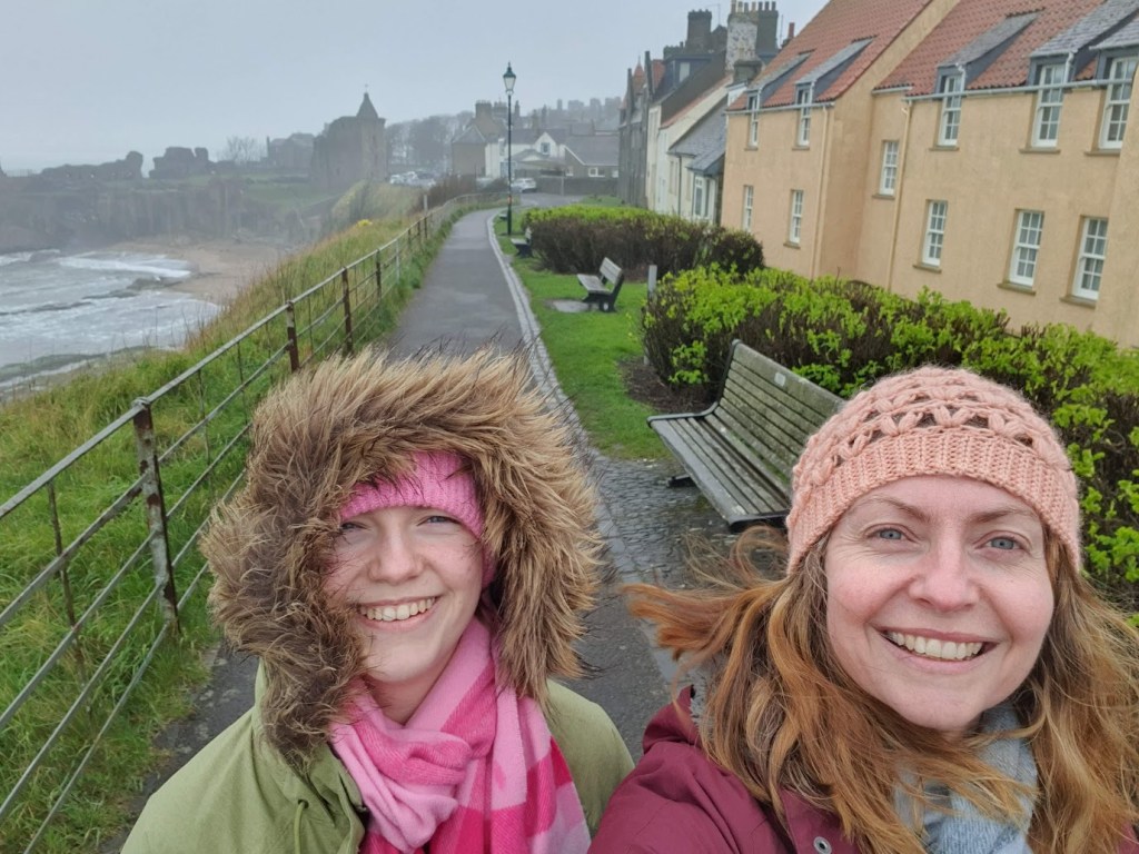 Eizabeth and Rachel by the sea on a wet and windy day in St Andrews.