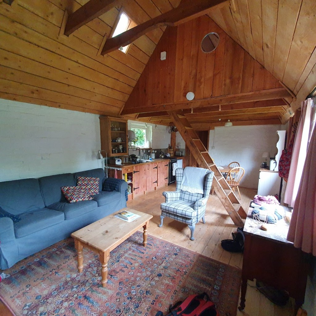 The living area in the bothy with a ladder going up to the mezzanine.