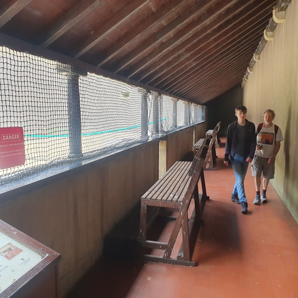 The spectator area beside the tennis court.