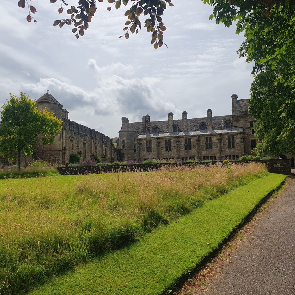 Falkland Palace from the rear with lawns and meadow. 
