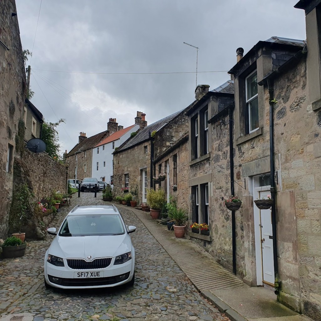 A cute lane with stone building on either side.