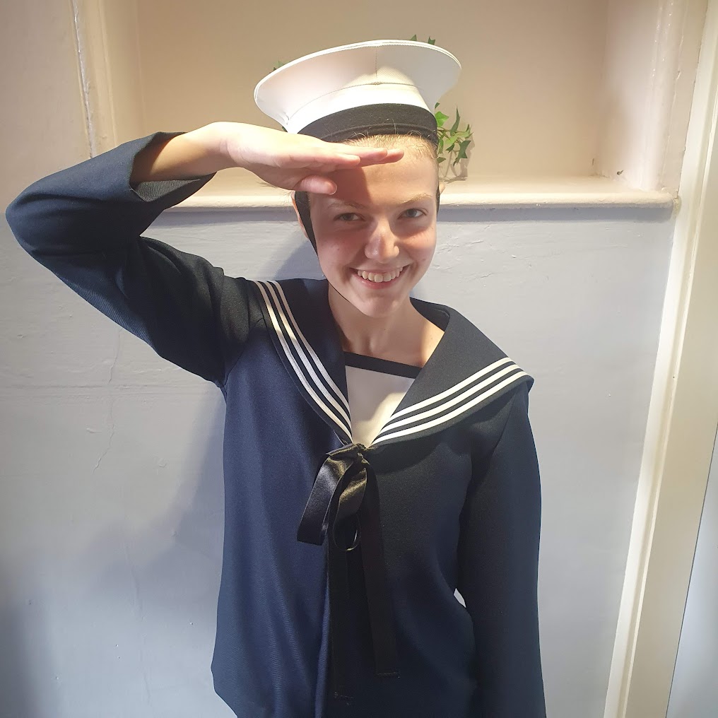Elizabeth doing a sailor's salute in the hornpipe outfit.
