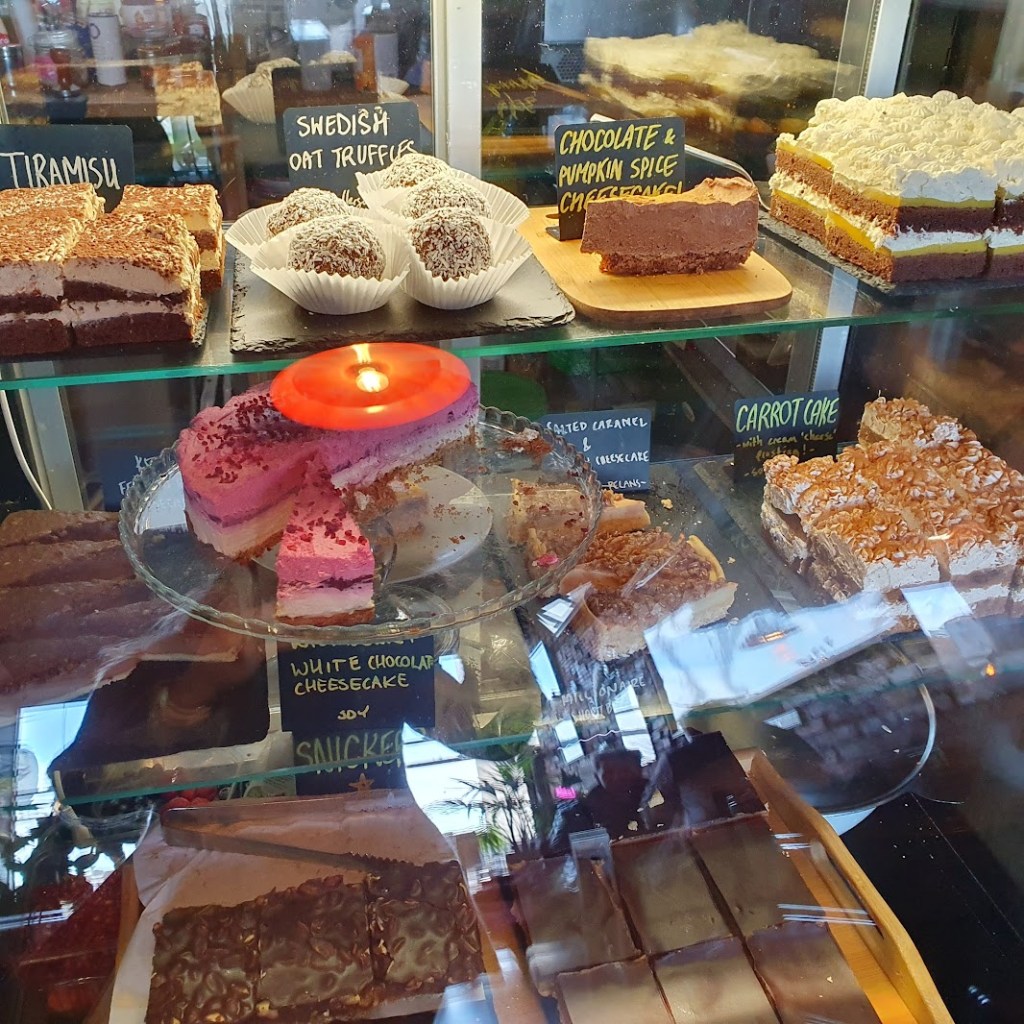 Lots of delicious cakes in a glass cabinet.