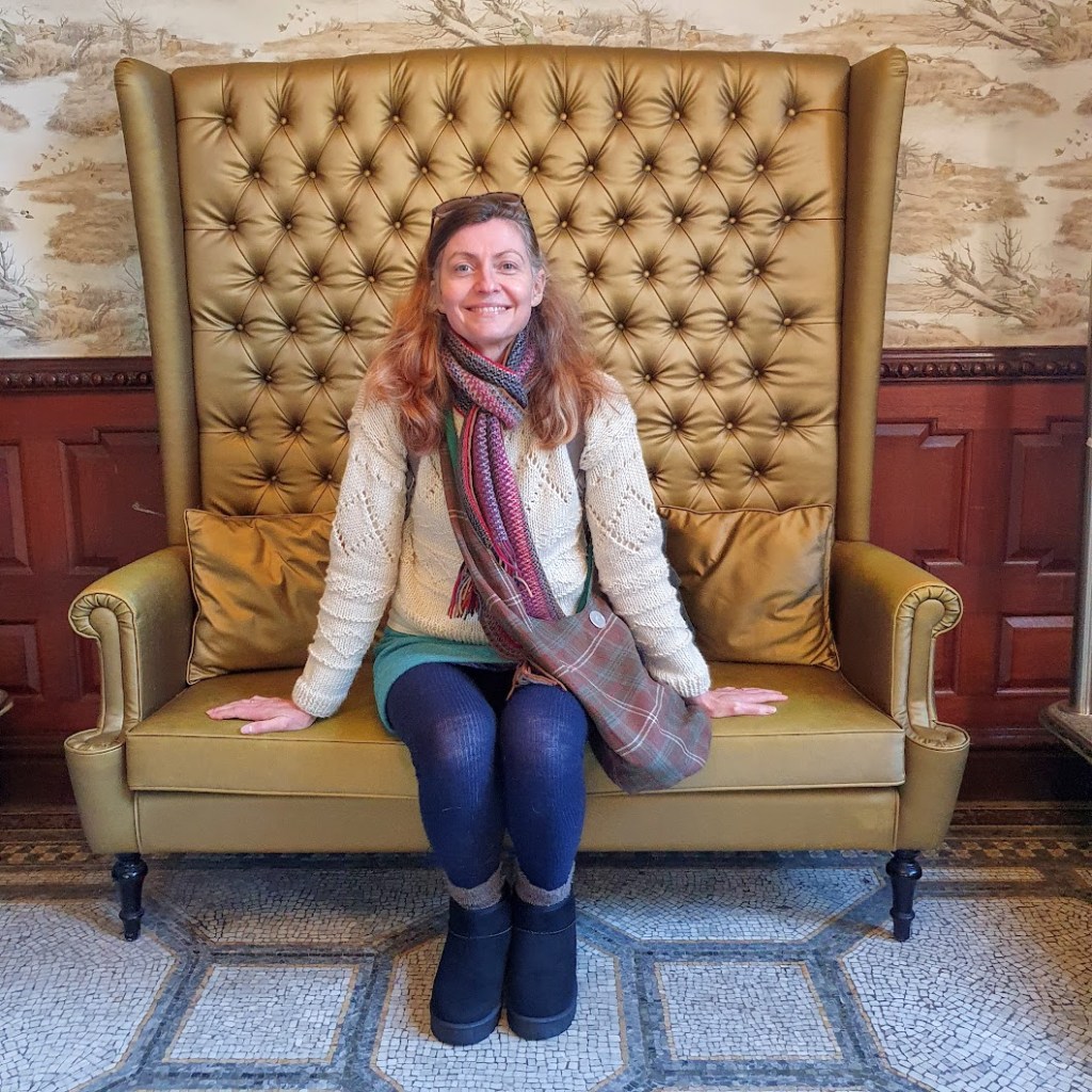 Me sitting in a a chair with a very high back.