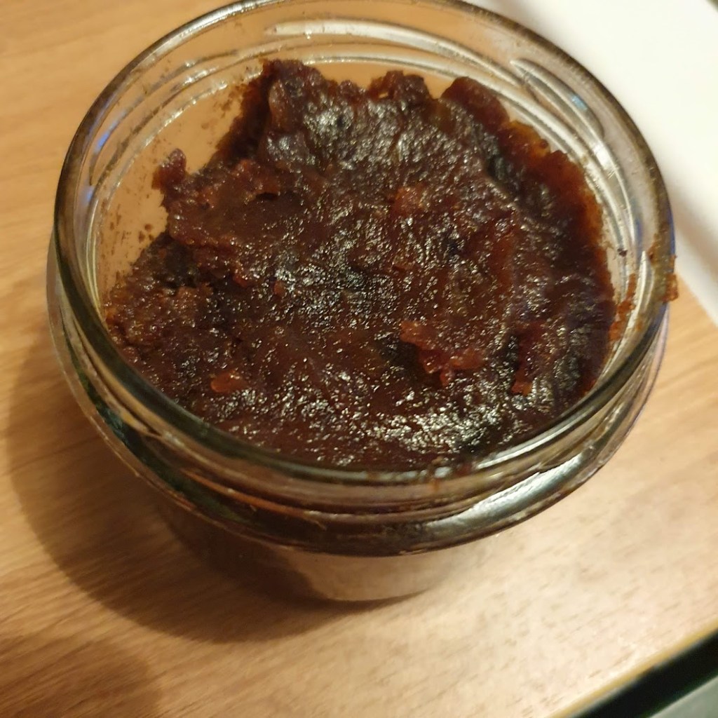 Black butter in a glass jar,