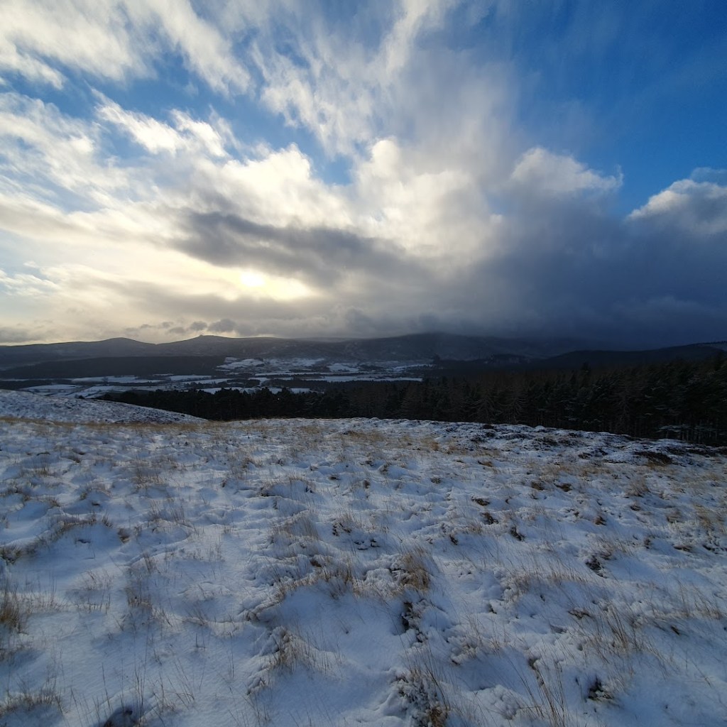 A mix of blue and cloudy sky over a snowy landscape.