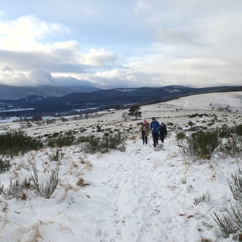 Elizabeth, Ben and Daniel walking up the hill to Tom's Cairn.
