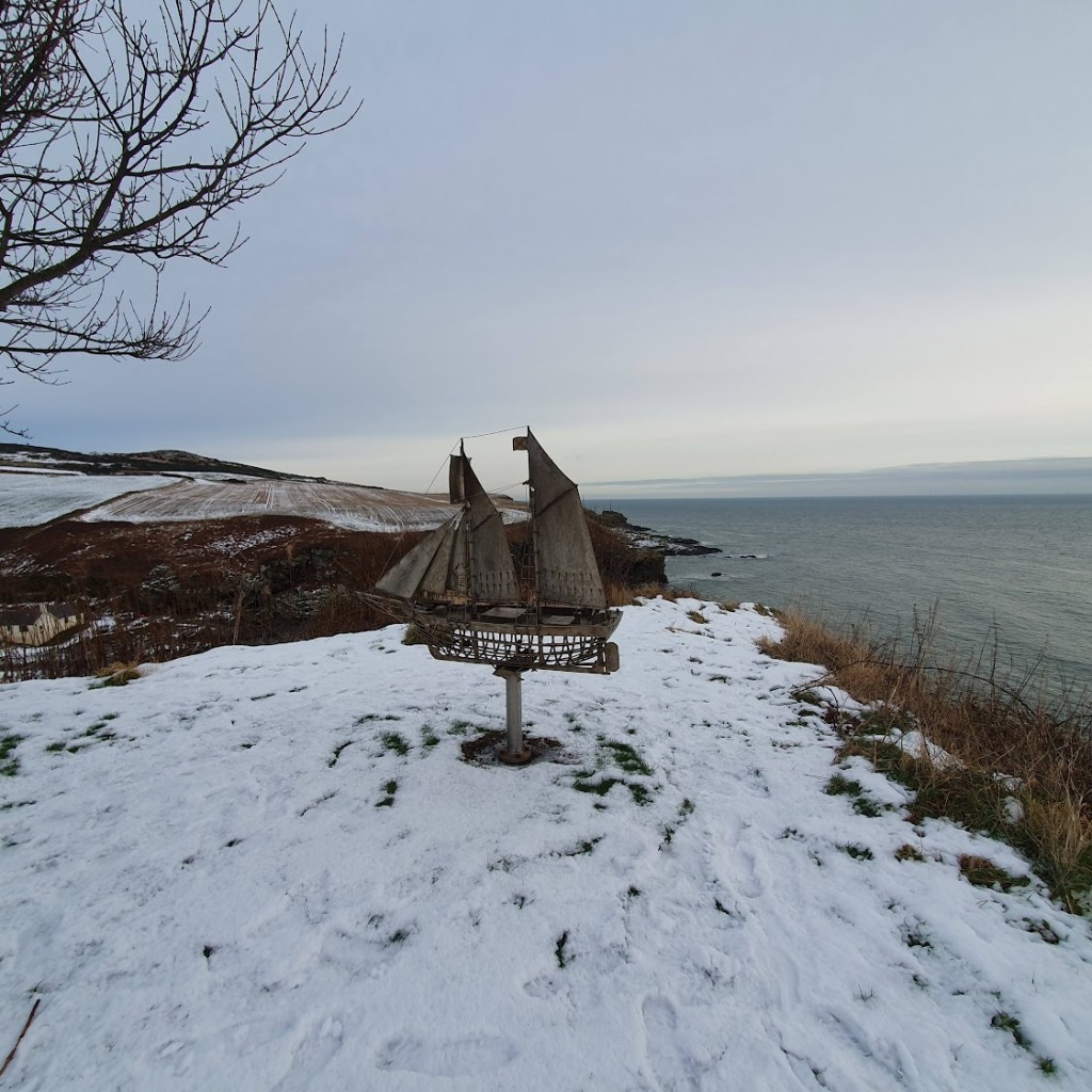 A statue of a ship in Newton Hill overlooking the sea.