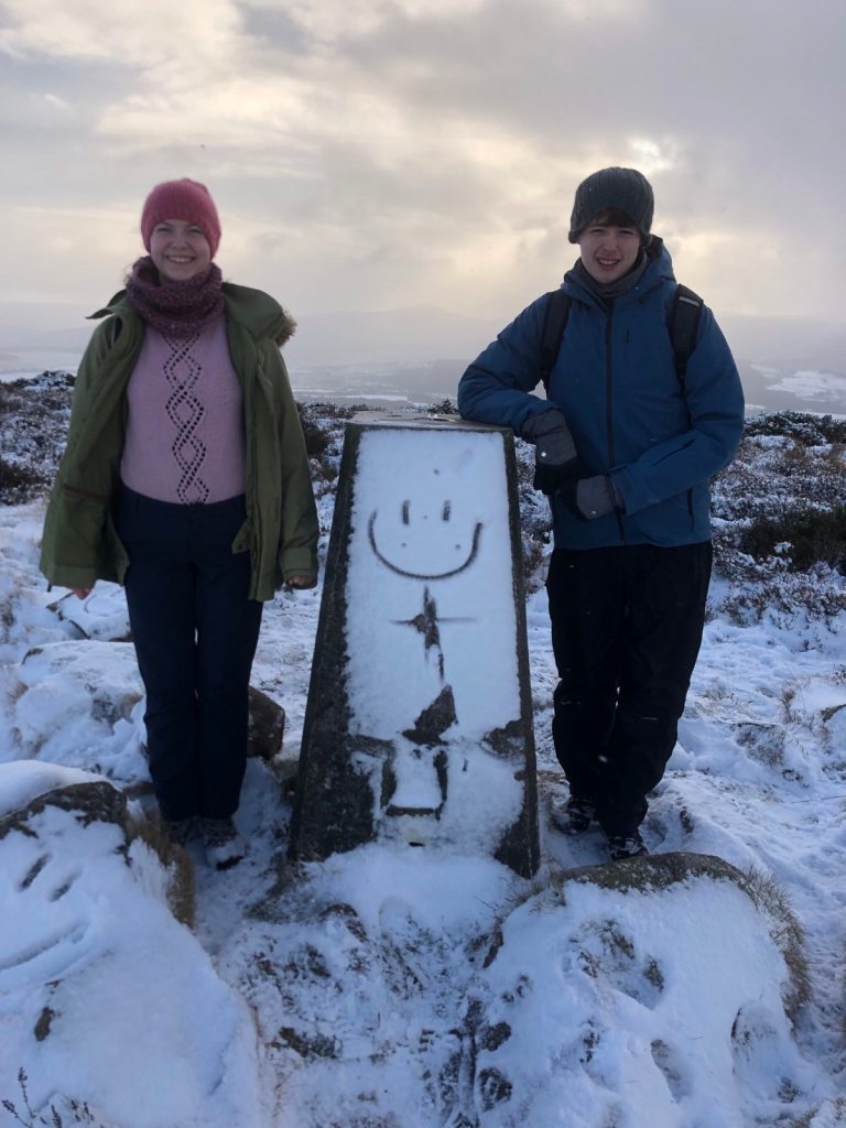 Daniel and Elizabeth standing next to a sign.