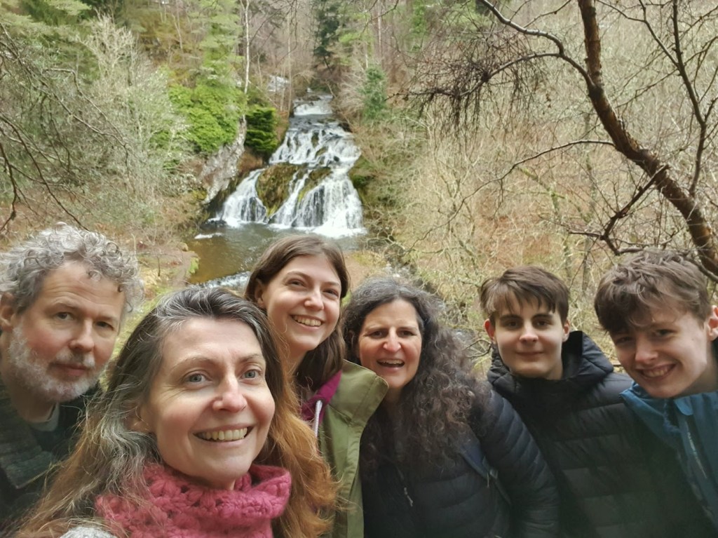 A selfie of all of us with the waterfall behind.