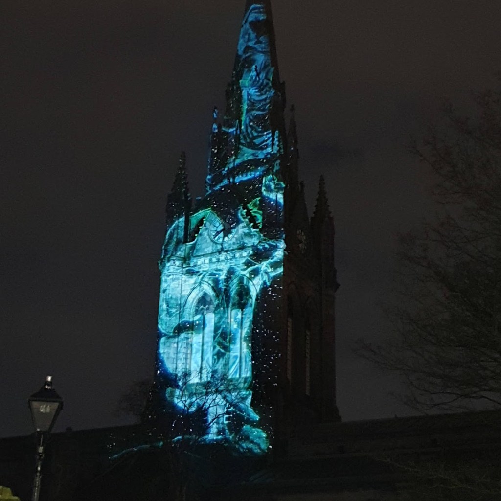 A light show on the front of the St Nicholas church spire. 