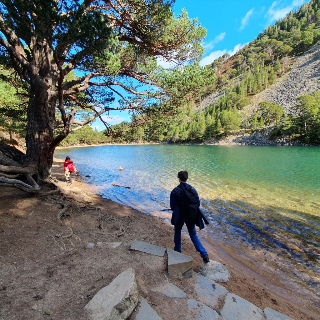 A different angle of the Green Loch with Elizabeth and Daniel walking along the shore.