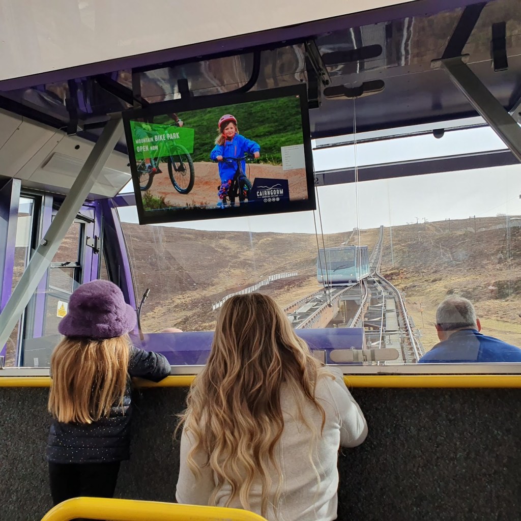 Looking through the window up the mountain on the forked part of the track with the second carriage coming down the hill. 