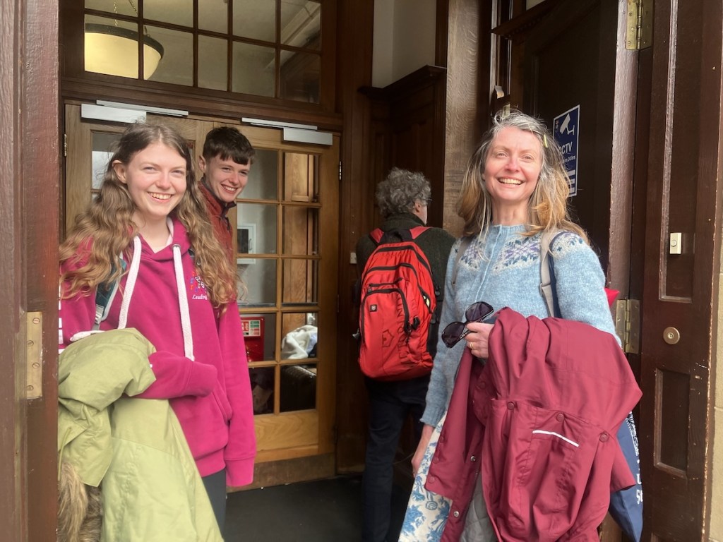Daniel, Elizabeth, Rachel and Ben outside the entrance all smiling except for Ben who has his back to the camera as he tried to figure out how to get in.