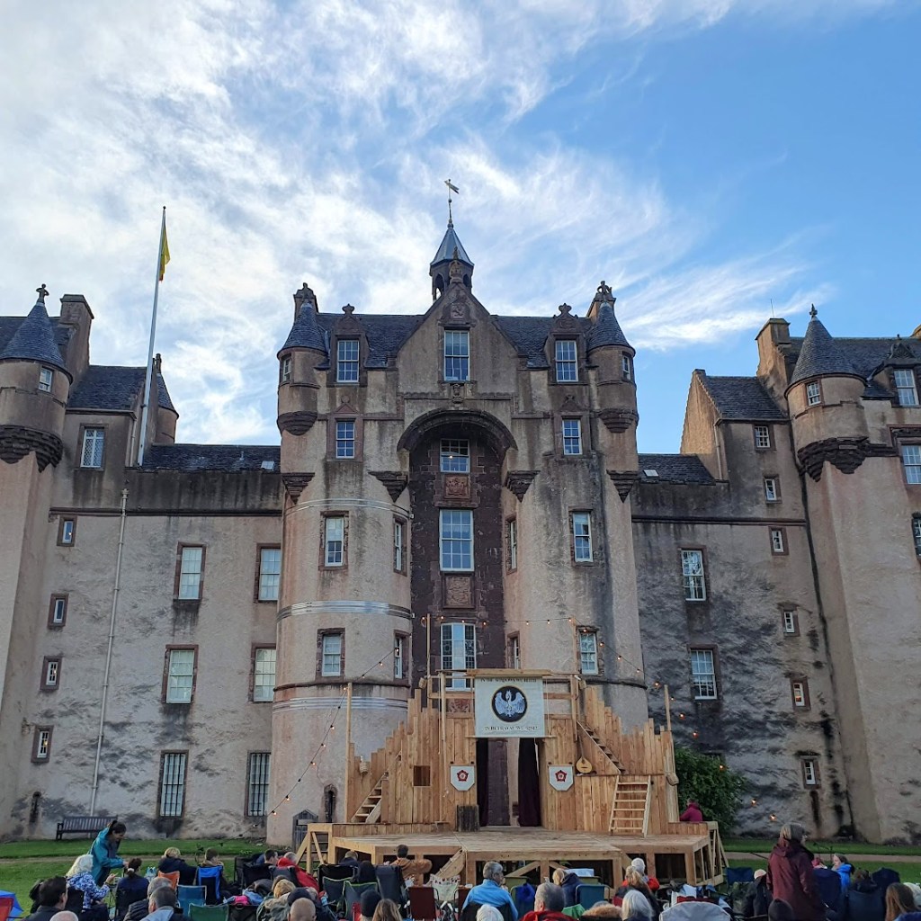 Another view of the castle with the stage and people sitting in front waiting for the show to begin.