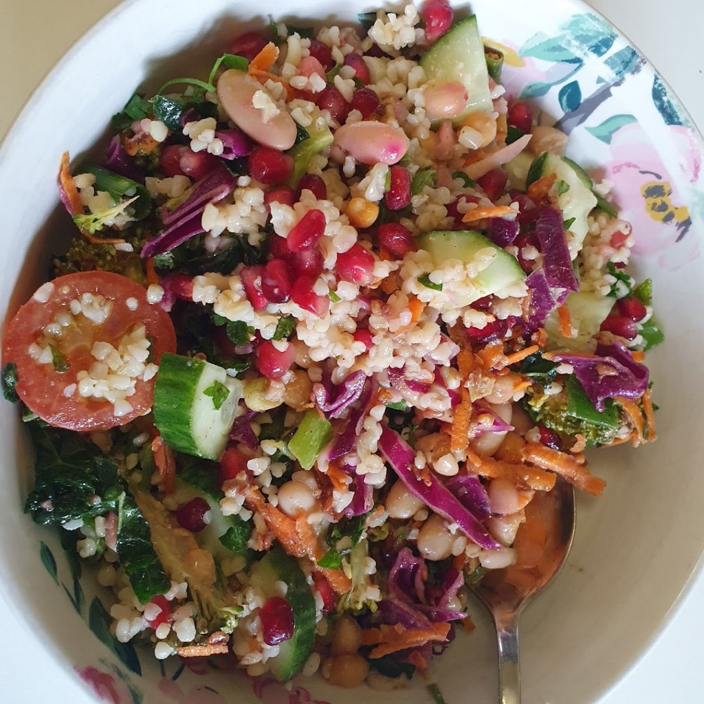 A fresh salad with tabbouleh and red cabbage plus carrot. 
