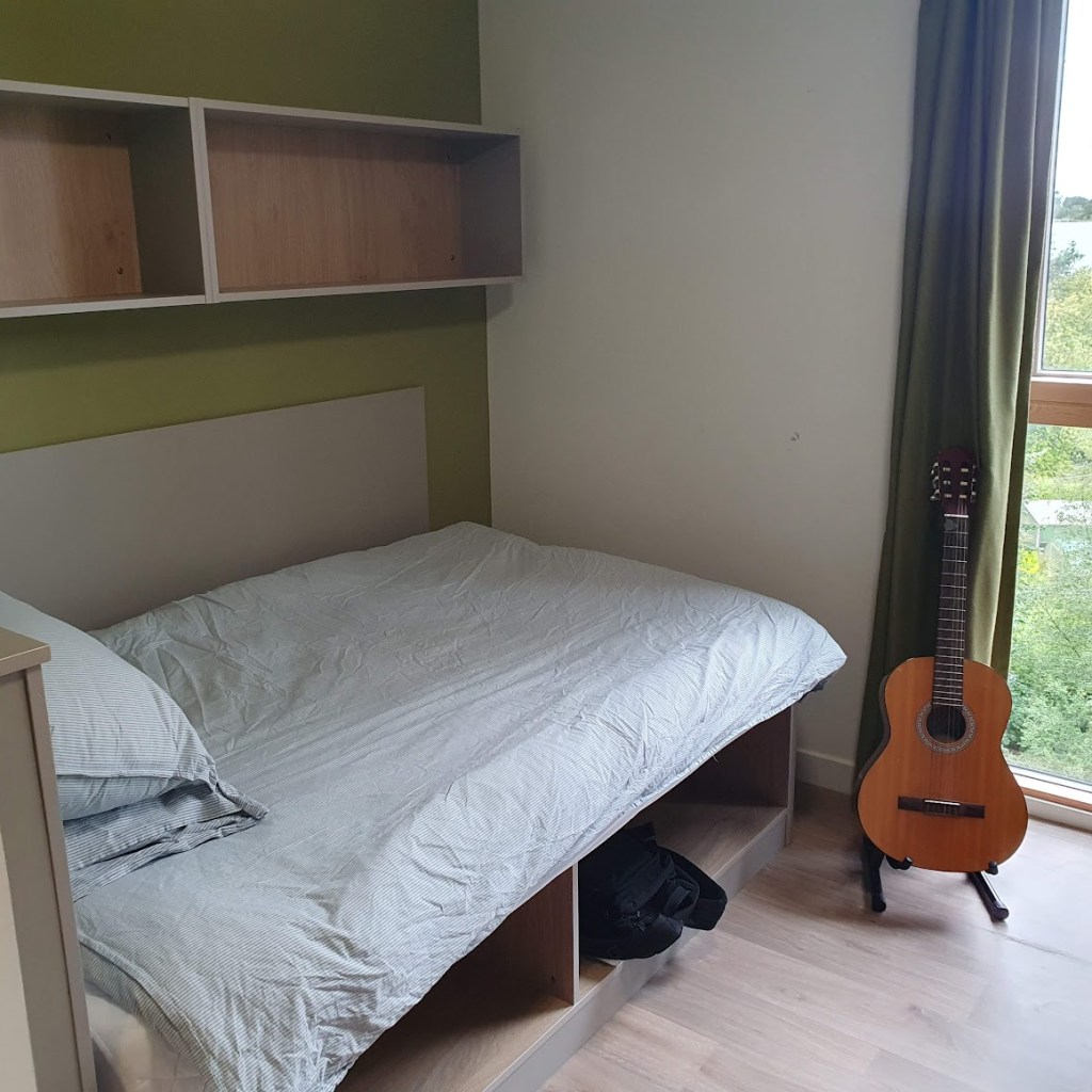 A view of his bed all made up.