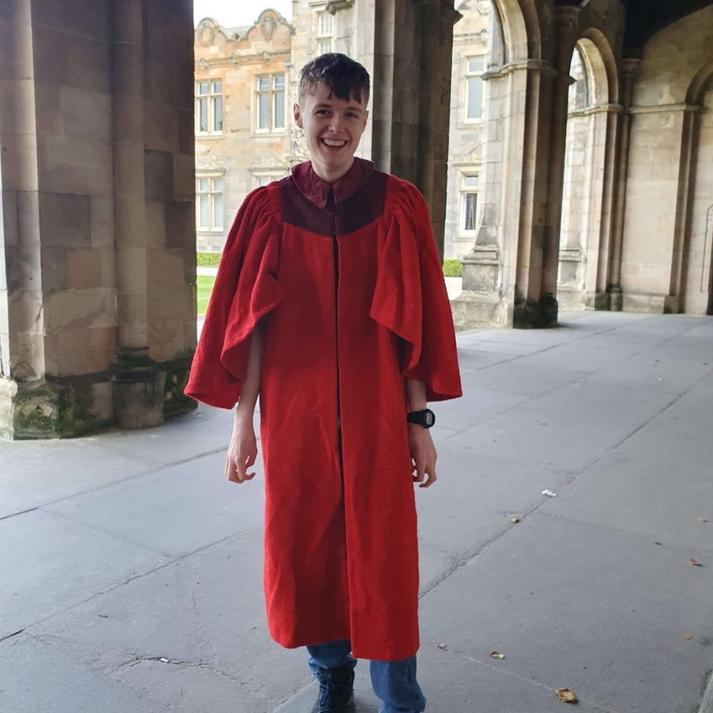 Daniel in his gown smiling for the camera