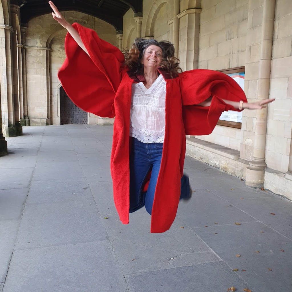 Rachel wearing the gown and doing a jumping shot