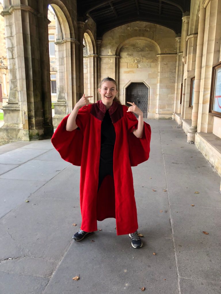 Elizabeth in the gown putting on a strange face.